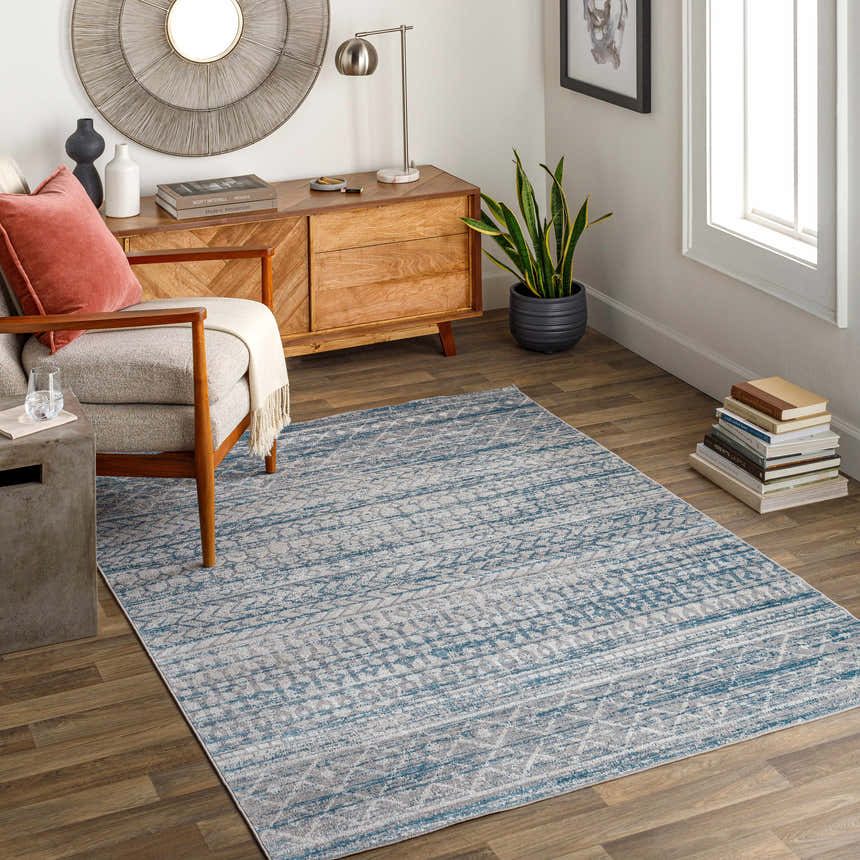 Living room scene with Tambac Blue Washable Area Rug, wood floors, mid-century modern chair and cabinet. Roomscene-Rectangle