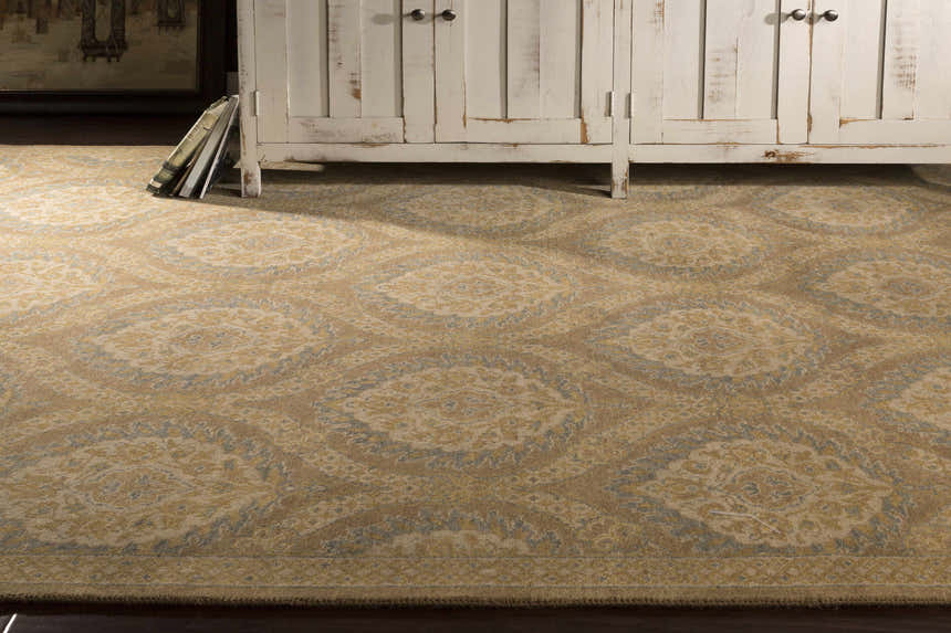 Close-up of Olson Area Rug, a hand-knotted wool rug in neutral tones with a contemporary medallion pattern. Styleshot