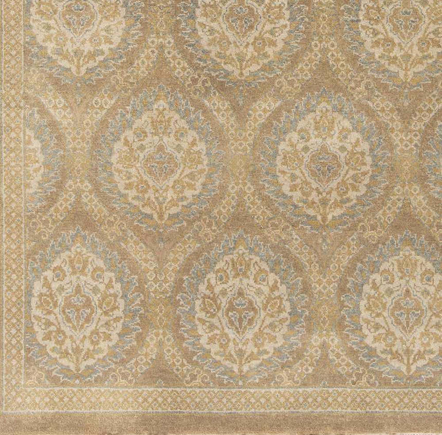Close-up of the hand-knotted Olson Area Rug. This 100% wool rug features a contemporary damask pattern in tan, gold, and blue. Swatch