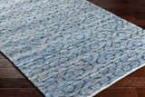 Close-up of the hand woven Gurit Blue & Brown Area Rug showing its recycled fabric texture and contemporary pattern. Corner
