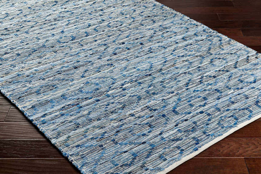Close-up of the hand woven Gurit Blue & Brown Area Rug showing its recycled fabric texture and contemporary pattern. Corner