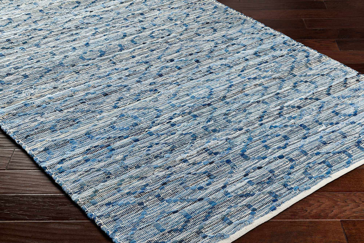 Close-up of the hand woven Gurit Blue & Brown Area Rug showing its recycled fabric texture and contemporary pattern. Corner