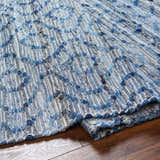 Close-up of the hand woven Gurit Blue & Brown Area Rug, a contemporary rug made of recycled fabric. Fold