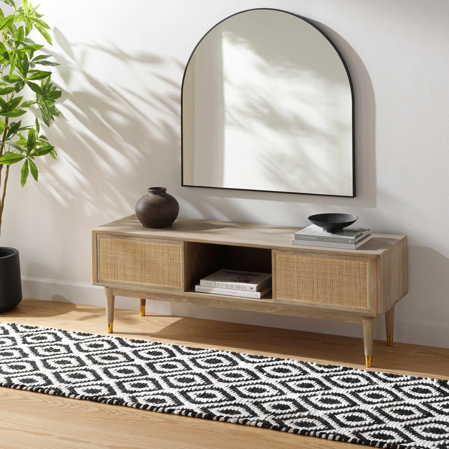 Entryway scene with a black and white Helmi Area Rug runner, wood console table, mirror, and plant. Roomscene-Runner