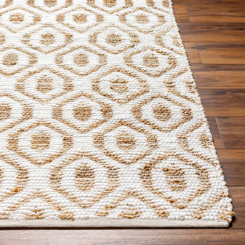 Close-up of the hand woven Isaye Beige Area Rug showing the jute and recycled fabric geometric pattern. Front