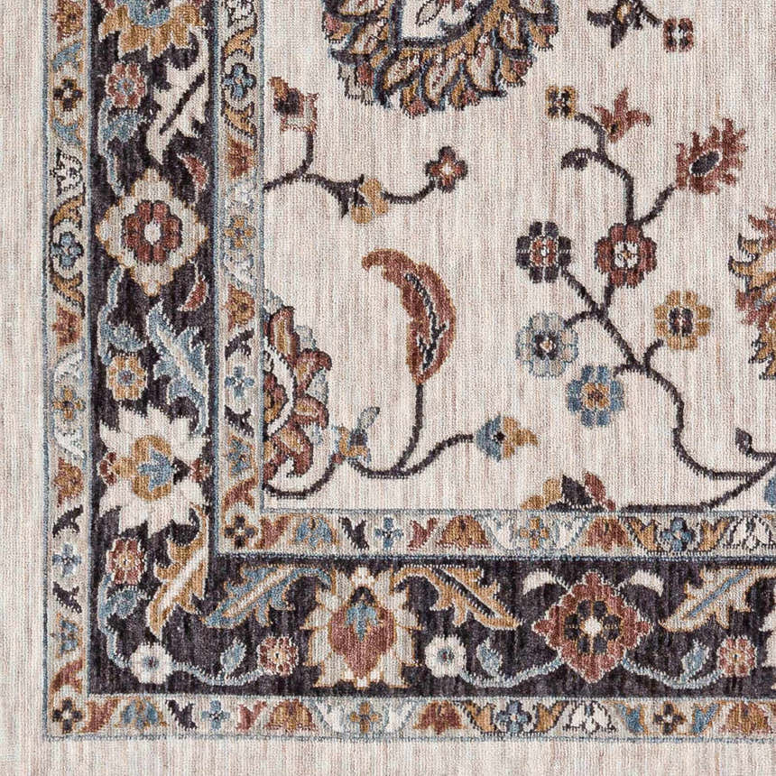 Close-up of the Adjoa Area Rug showing floral and vine pattern in black, brown, blue, and cream. Farmhouse style. Swatch
