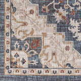 Close-up of the Lewa Blue Area Rug, featuring a traditional floral pattern in navy, light gray, and brown tones. Swatch