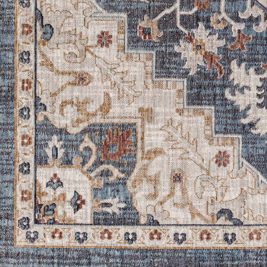 Close-up of the Lewa Blue Area Rug, featuring a traditional floral pattern in navy, light gray, and brown tones. Swatch