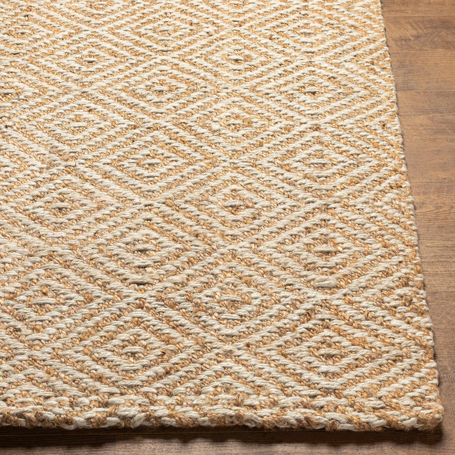 Close-up of Eriko Area Rug showing geometric diamond pattern and hand woven jute texture in natural, tan, and beige tones. Front