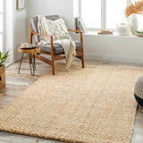 Living room scene with a tan Eriko Area Rug, wood chair, and natural light. Roomscene-Rectangle
