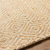 Close-up of Eriko Area Rug showing hand woven jute texture and geometric diamond pattern in tan, beige, and natural. Texture