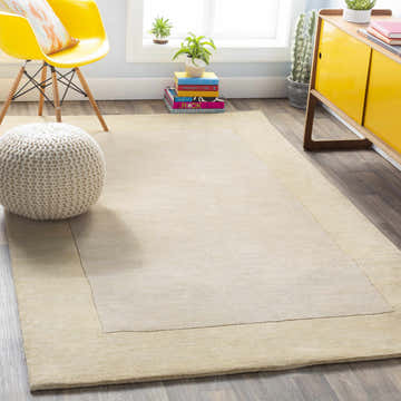 Living room scene with a Bordered Solid Beige Wool Rug, yellow chair, and bright yellow cabinet. Roomscene-Rectangle