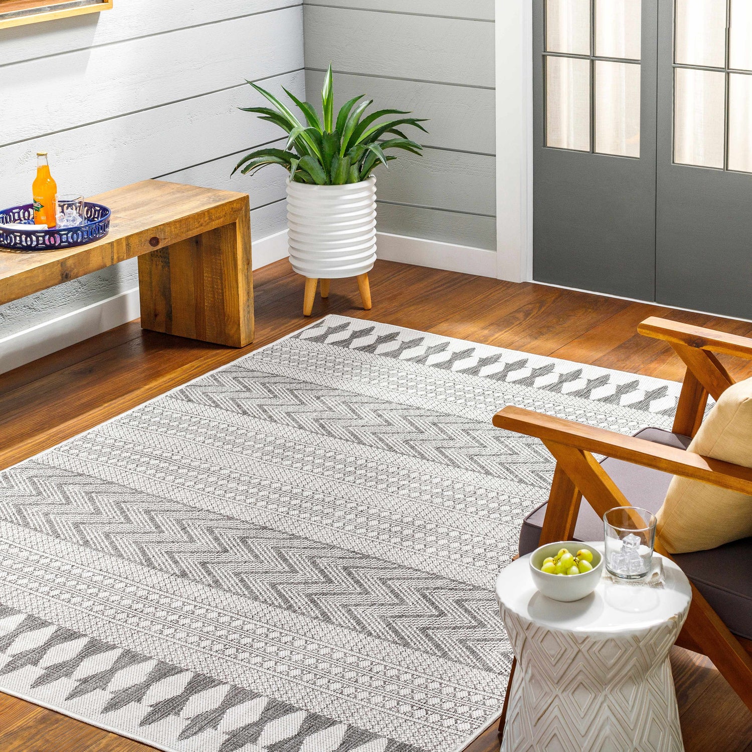 Entryway with Asif Gray Area Rug, wooden bench, potted plant, and chair. Farmhouse style with light gray walls. Roomscene-Rectangle