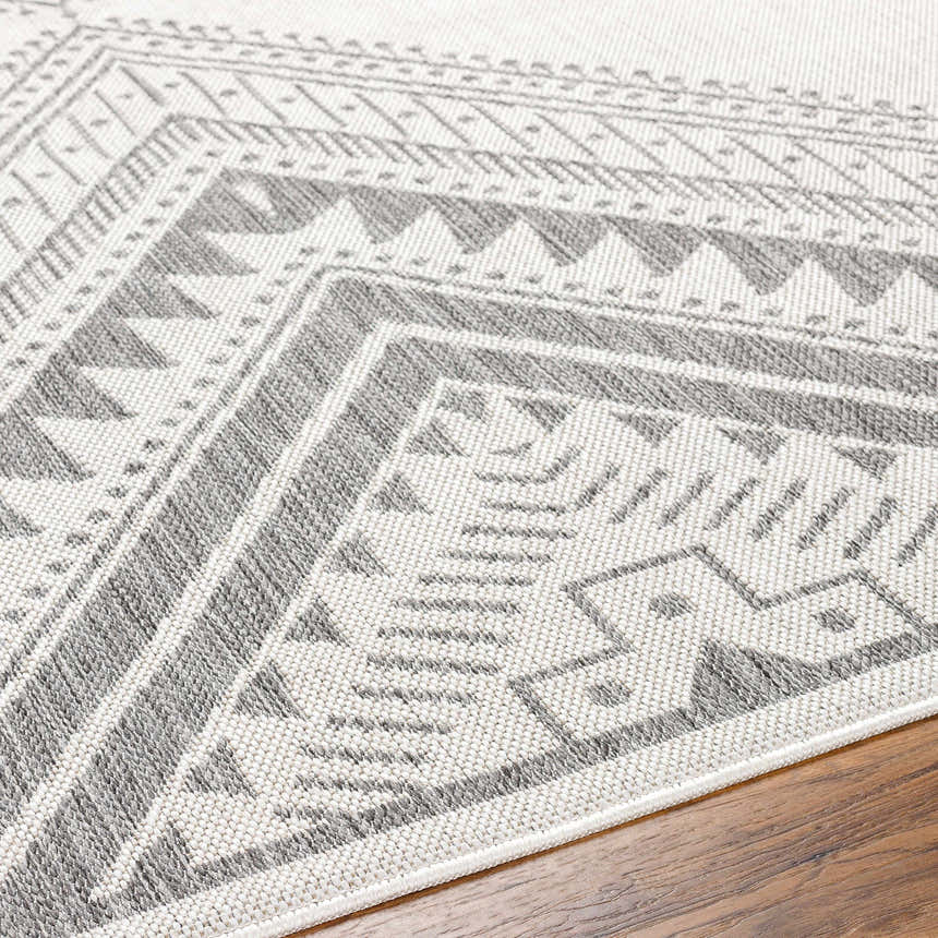 Close-up of the Deana Light Gray Area Rug showcasing its geometric, bohemian-inspired pattern and woven texture. Texture