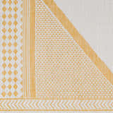 Close-up of the Efrem Mustard Area Carpet, featuring a geometric design with diamond, stripe, and chevron patterns in mustard and off-white. Swatch
