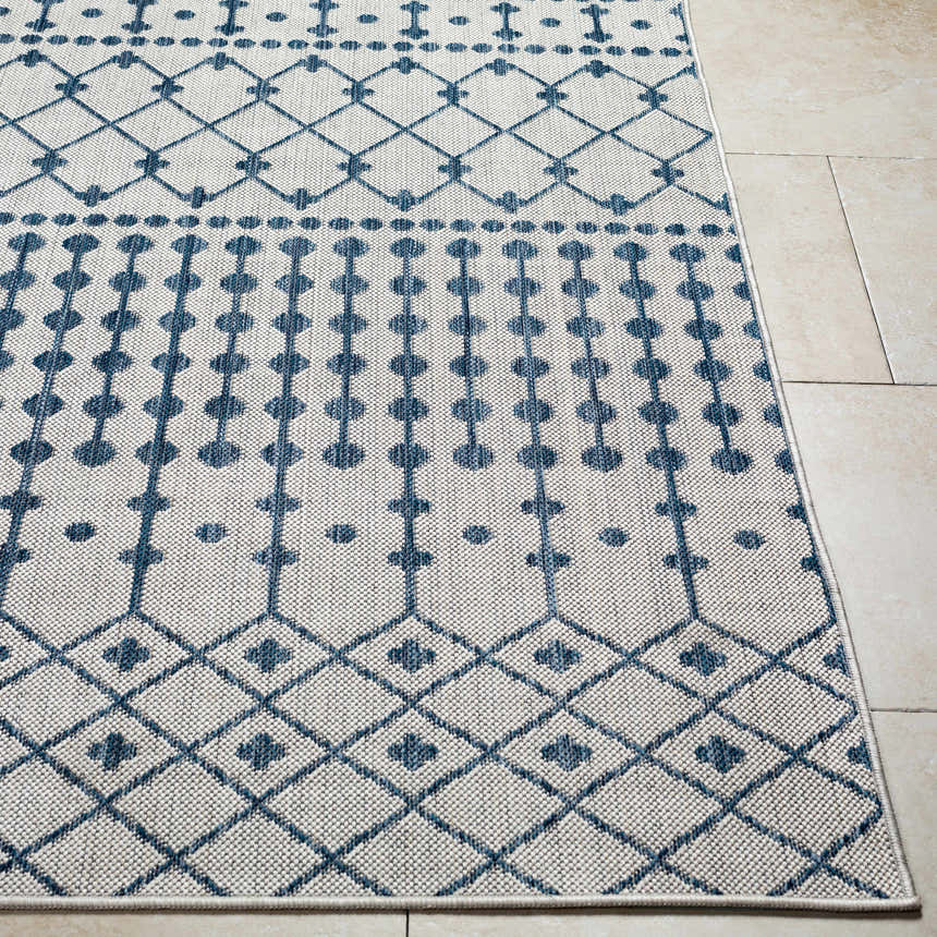 Close-up of the Lali Blue & Gray Area Rug, featuring a geometric diamond and dot pattern in denim blue on a light gray background. Front