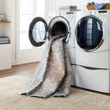 Emke Rust Washable Area Rug in a laundry room being washed in a front load washing machine. Easy care rug. Washing-Machine