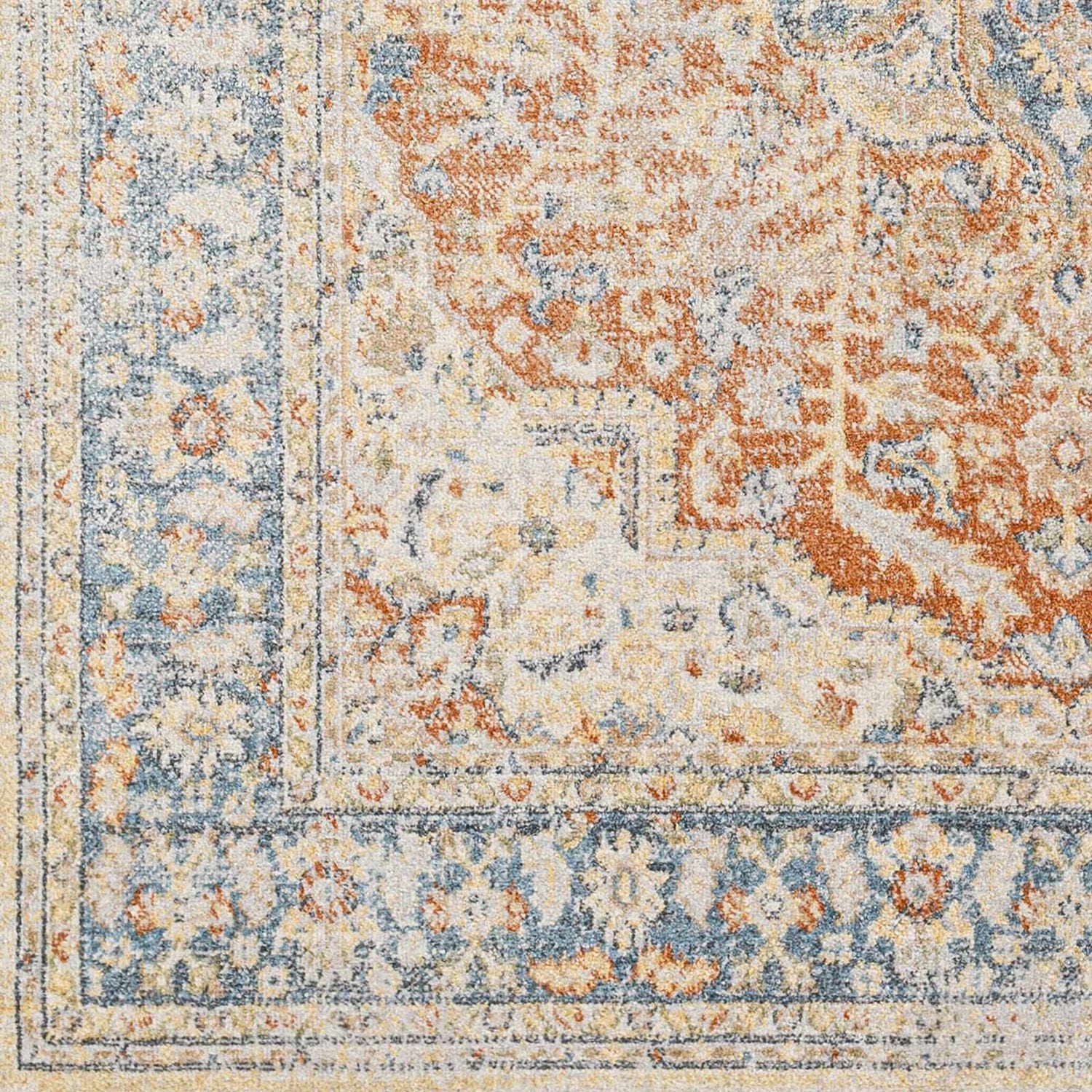 Close-up of the Emke Rust Washable Area Rug, featuring a traditional design in dark beige, rust, and blue tones. Swatch