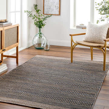 Living room scene with a navy geometric Elle Jute Rug, wood cabinet, chair, and plants. Scandinavian style. Roomscene-Rectangle