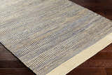Close-up of the hand woven Blue Elle Area Rug. Jute rug with charcoal and natural geometric pattern. Corner