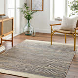 Living room scene with the blue Elle Area Rug, jute rug with geometric pattern, wood furniture, and natural light. Roomscene-Rectangle