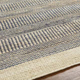 Close-up of Blue Elle Area Rug showing denim and natural jute geometric, hand-woven texture. Texture