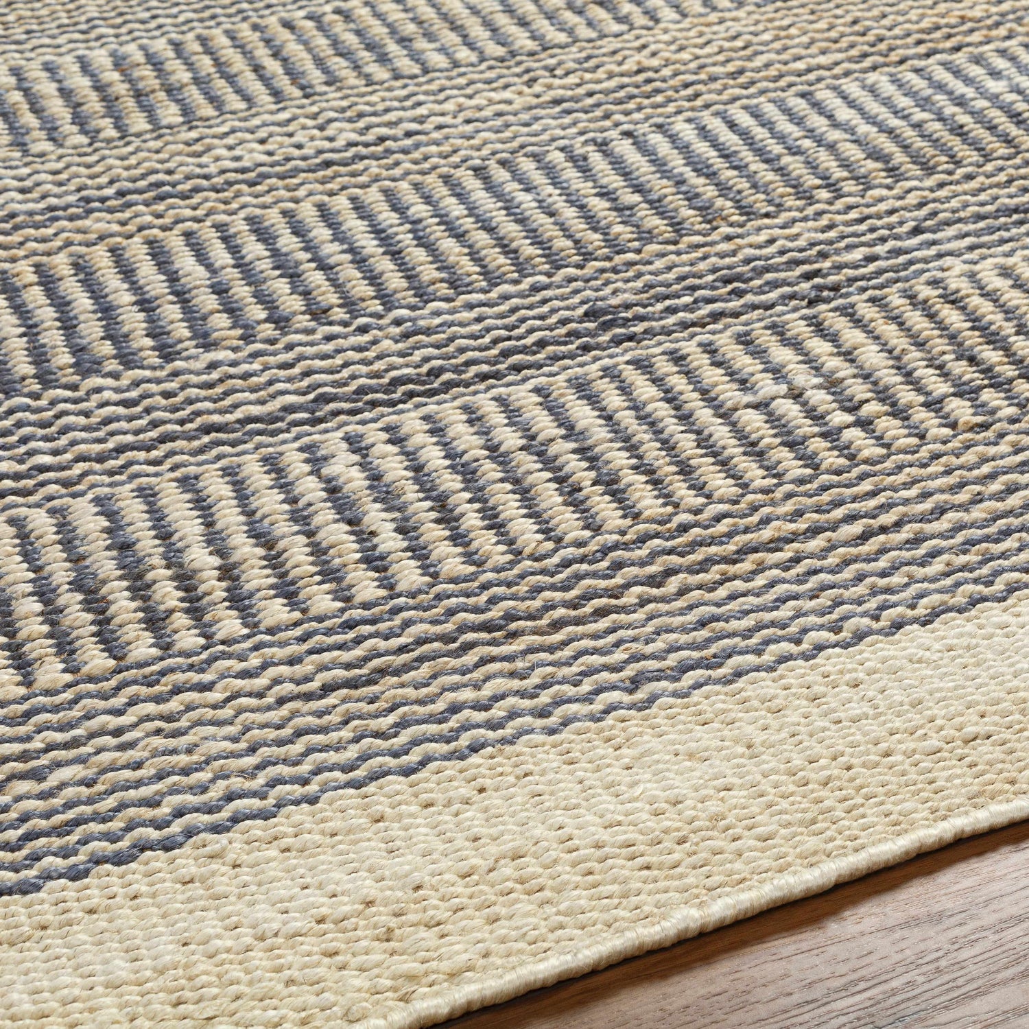 Close-up of Blue Elle Area Rug showing denim and natural jute geometric, hand-woven texture. Texture