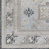 Close-up of Sultanbeyli Area Carpet. Machine-woven rug with black, cream, gray, and teal traditional pattern. Swatch