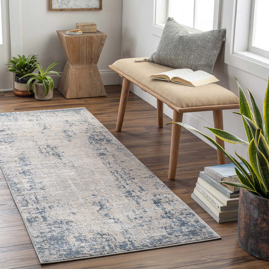 Entryway scene with blue and gray Saltair Textured Luxe Rug, wood bench, plants, and books for a cozy, stylish space. Roomscene-Runner