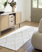 Entryway scene with Amani White Washable Rug, wood floors, console table, round mirror, and neutral decor. Roomscene-Runner