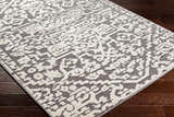 Close-up of the Beren Gray Washable Area Rug, showing a bone and gray traditional pattern with a slightly raised texture. Corner