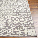 Close-up of the Beren Gray Washable Area Rug showing the bone and gray traditional pattern and textured weave. Front