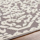 Close-up of the Beren Gray Washable Area Rug, featuring a bone and gray traditional pattern with a soft, textured feel. Texture