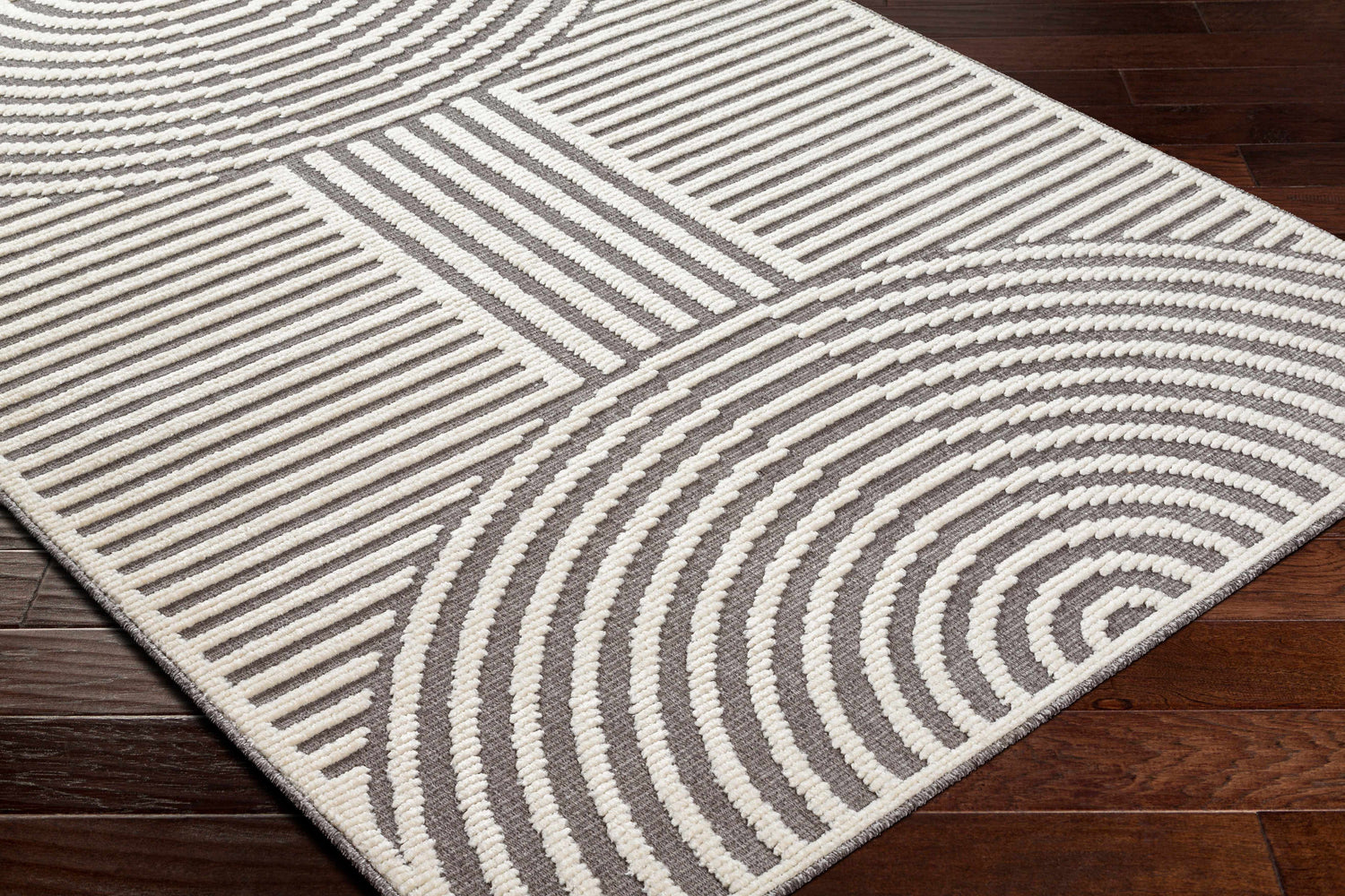 Close-up of the Deron Gray Rainbow Washable Rug featuring a contemporary geometric design in gray and white. Corner