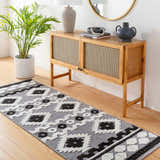 Entryway with wood floors and Noki Washable Textured Southwestern Rug runner in gray, black, and white. Wood cabinet with decor. Roomscene-Runner