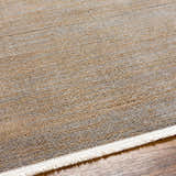 Close-up of the Halyn Area Rug showing beige, gray, and brown horizontal stripes with a white fringe on wood flooring. Texture