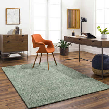 Bright home office with wood floors and Alyra Green Solid Area Rug, desk, orange chair, and blue pouf. Roomscene-Rectangle