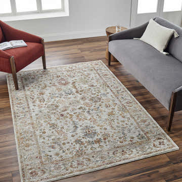 Living room scene with a tan Asabi textured rug, gray sofa, and brick red chair on a dark wood floor. Roomscene-Rectangle
