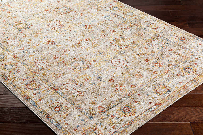 Close-up of the Duong Beige Textured Rug with Fringes, featuring a traditional floral pattern in brick red, mustard, and blue. Corner
