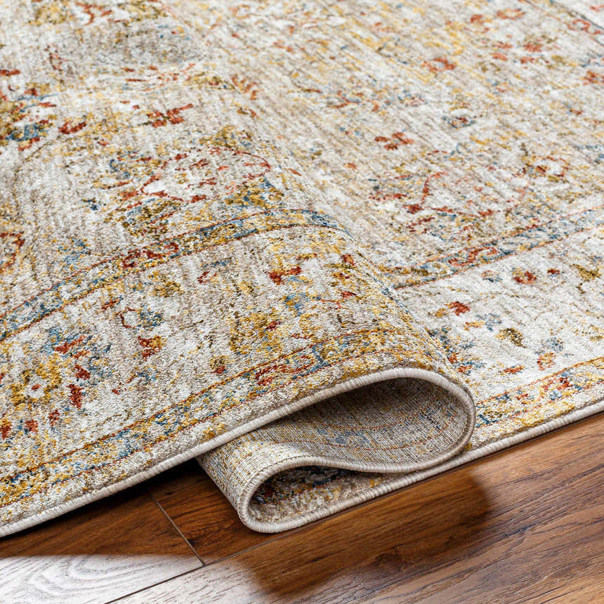 Close-up of the Duong Beige Textured Rug showing its traditional pattern, brick red, mustard, and blue colors. Fold