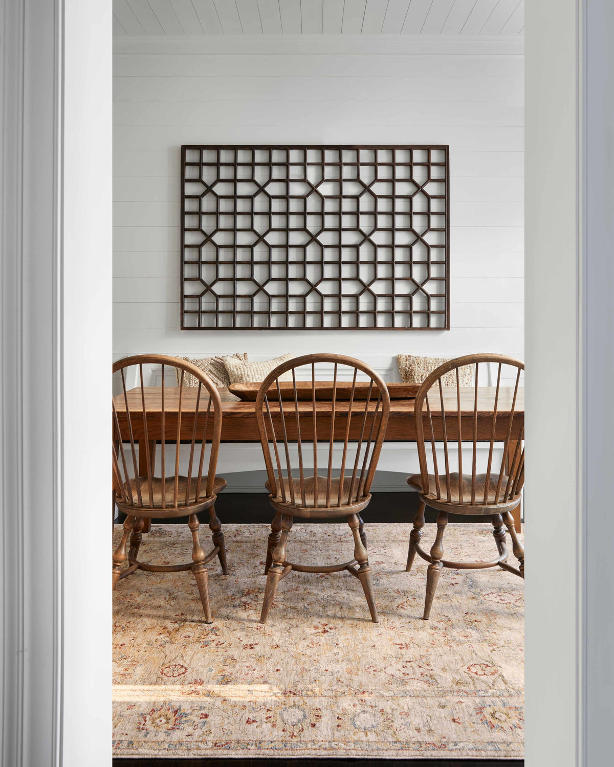 Farmhouse dining room with wood table and chairs on a Duong Beige Textured Rug. White walls and natural light. Roomscene-Rectangle