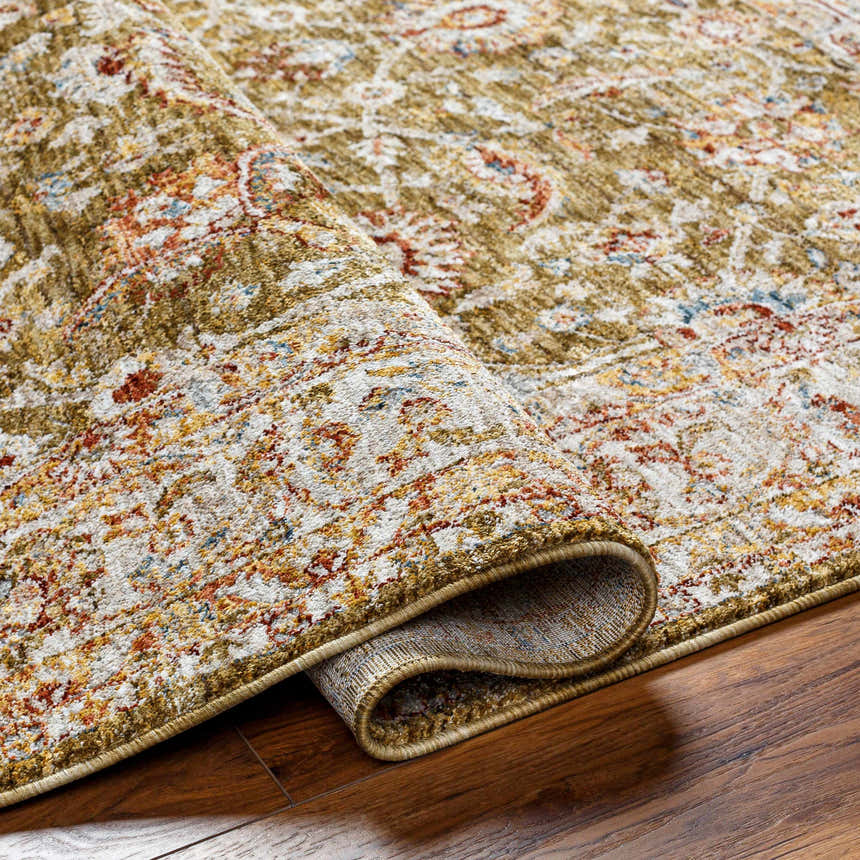 Close-up of the Dyan Green Textured Rug showing its farmhouse style, olive, sage, and tan colors, and machine-woven construction. Fold