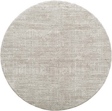 Close-up of a round Dekan Area Rug in beige. The rug has a subtle geometric pattern and a soft, textured look. Design-Round-53