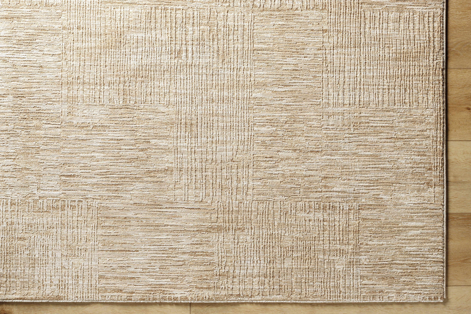 Close up of the Goren Beige Area Rug showing its textured, contemporary khaki and tan pattern. Corner