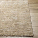 Close-up of a textured Goren Beige Area Rug in tan and khaki on a light wood floor. Front