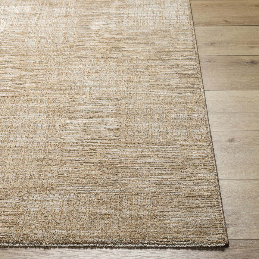 Close-up of a textured Goren Beige Area Rug in tan and khaki on a light wood floor. Front