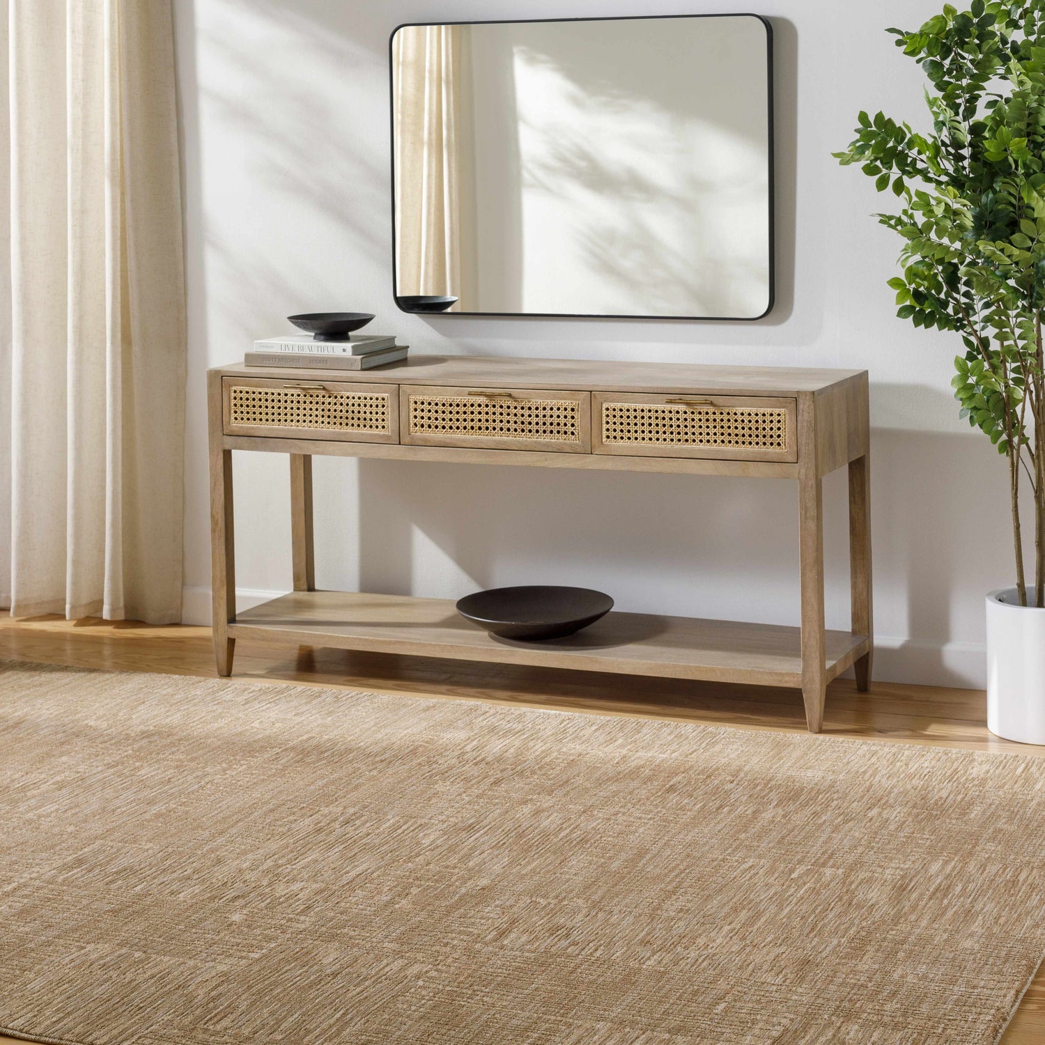 Entryway with a tan Goren Beige Area Rug, light wood console table, mirror, and potted plant. Roomscene-Rectangle