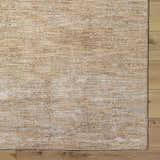 Close-up of the tan Jehan Area Rug showing its subtle, textured pattern and machine-woven construction. Corner