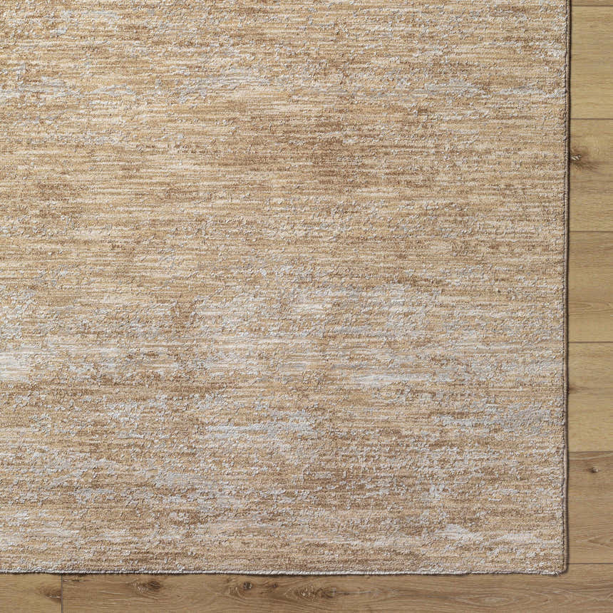 Close-up of the tan Jehan Area Rug showing its subtle, textured pattern and machine-woven construction. Corner
