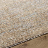 Close-up of the tan Jehan Area Rug showing its textured, machine-woven design and neutral color palette. Texture